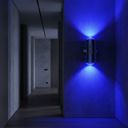 Wall-mounted light fixture emitting a blue glow in a dark hallway.