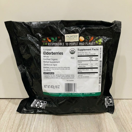 Black bag of Frontier Natural Products European Elderberries with label on a light wooden surface.